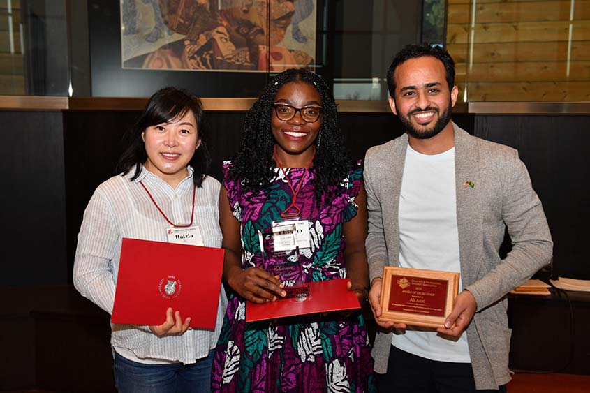 Three students receiving their awards